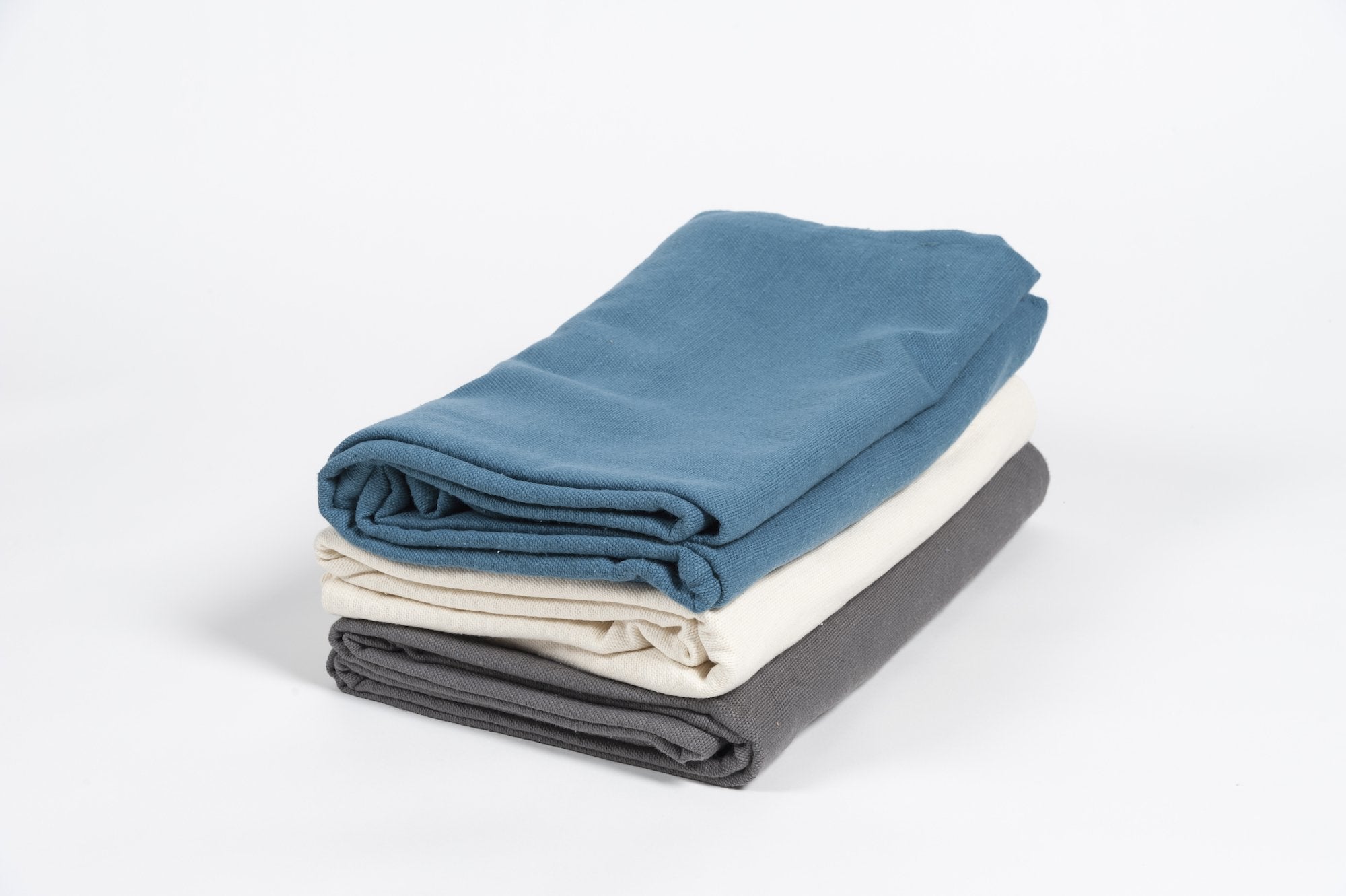 stack of three yoga blankets, blue, ocean and grey
